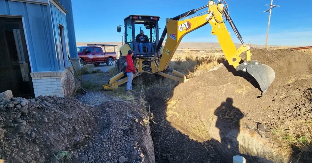 worksite photo of the landmark crew digging a trench with an excavator